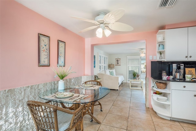 dining room featuring ceiling fan, light tile patterned flooring, and visible vents