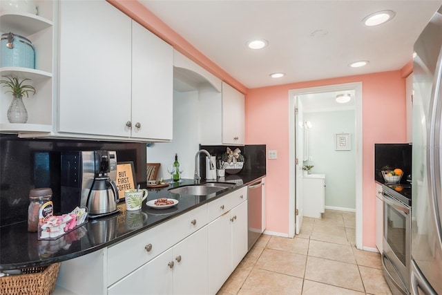 kitchen with stainless steel appliances, a sink, white cabinetry, open shelves, and dark countertops