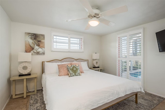 bedroom featuring a ceiling fan and baseboards