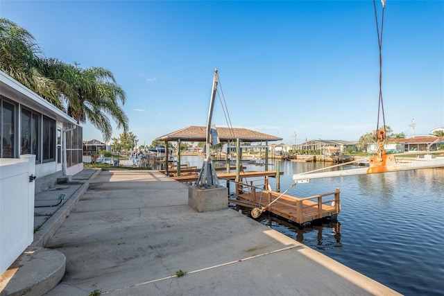 dock area with a water view and boat lift