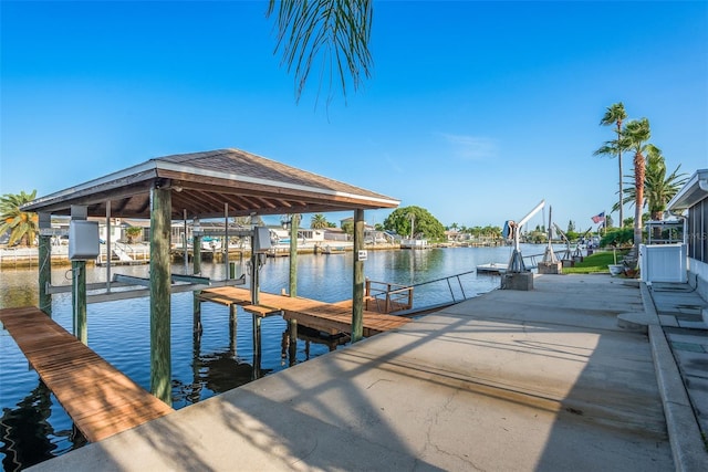 dock area with a water view and boat lift