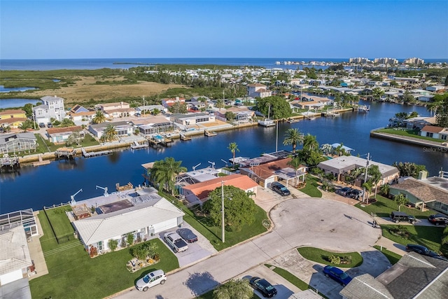 drone / aerial view featuring a water view and a residential view