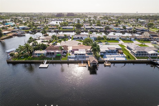 drone / aerial view featuring a water view and a residential view