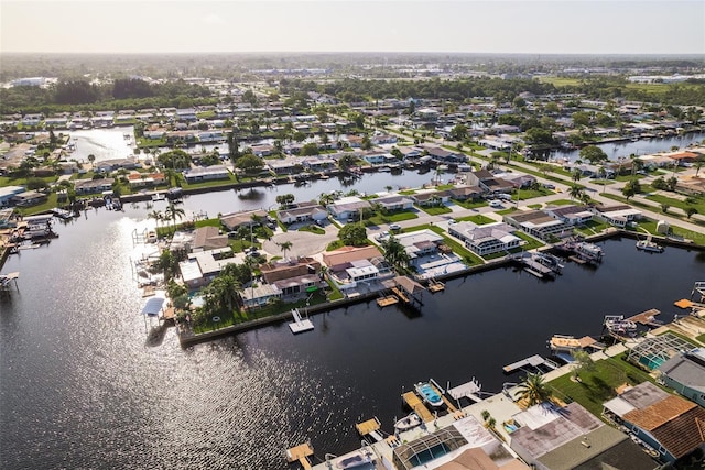 birds eye view of property with a water view and a residential view