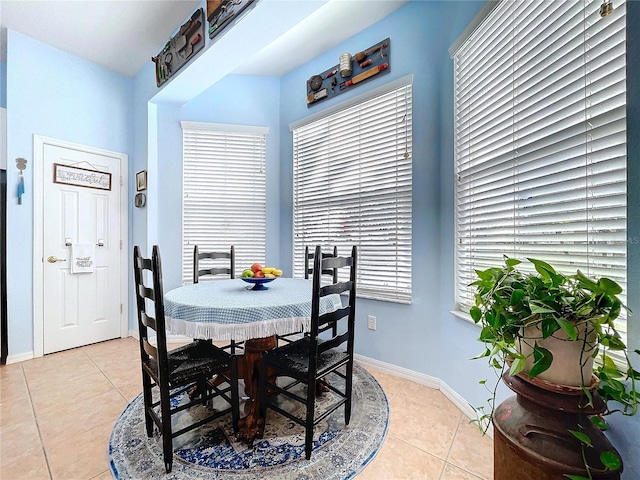 dining room featuring light tile patterned flooring and baseboards