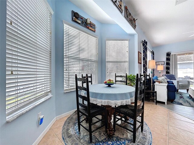 dining area featuring baseboards and light tile patterned floors