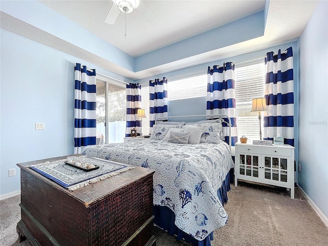 carpeted bedroom featuring a ceiling fan and baseboards