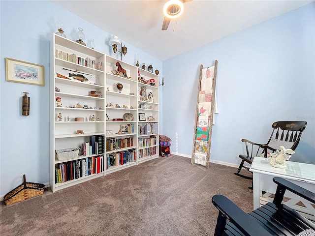 living area with carpet, ceiling fan, and baseboards