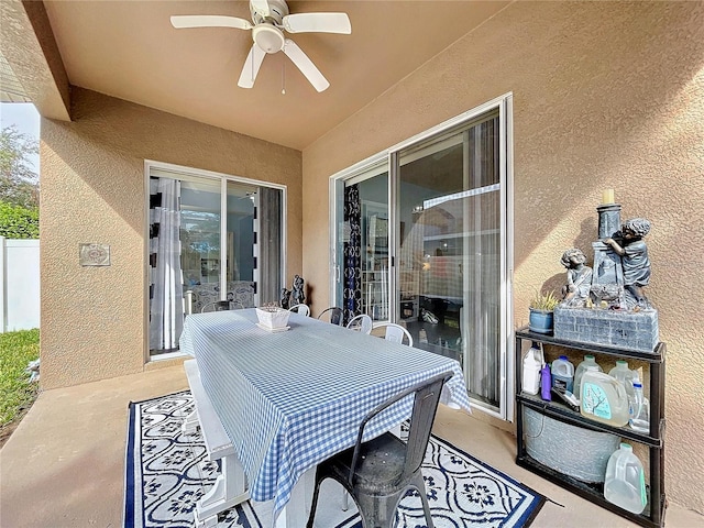 view of patio with fence and a ceiling fan