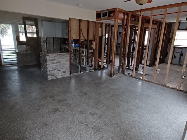 interior space featuring dark speckled floor and a ceiling fan