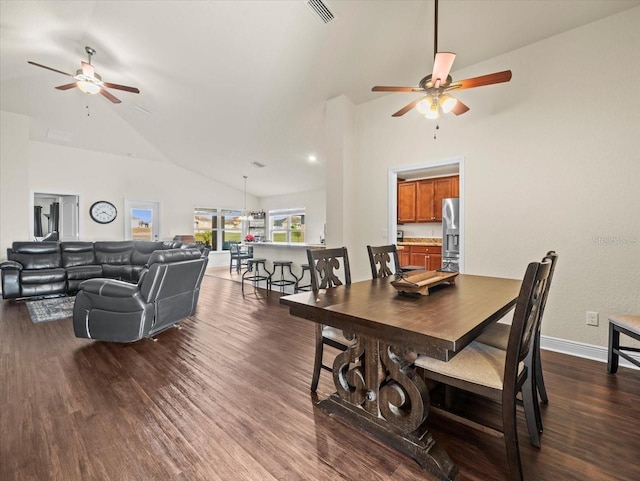 dining room with baseboards, visible vents, a ceiling fan, dark wood-type flooring, and high vaulted ceiling