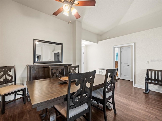 dining room featuring a ceiling fan, vaulted ceiling, baseboards, and wood finished floors