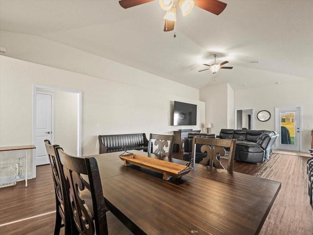 dining area featuring a ceiling fan, lofted ceiling, and wood finished floors