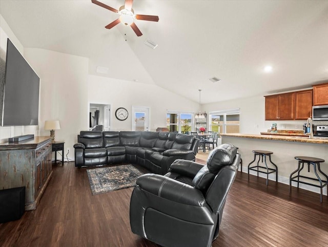 living area with a ceiling fan, dark wood-style flooring, and visible vents