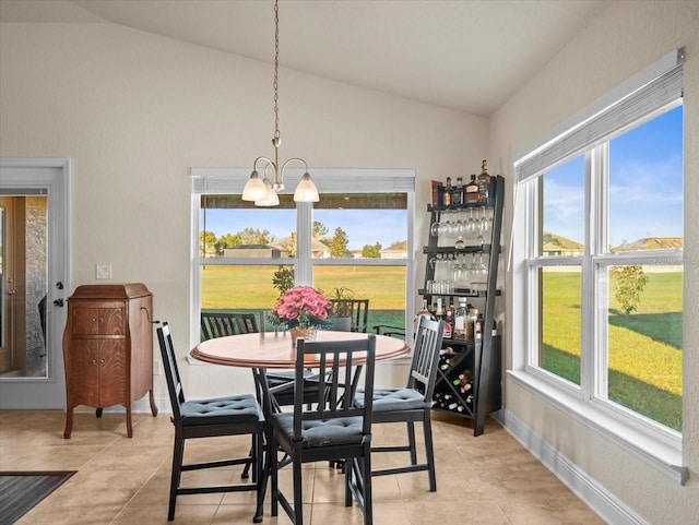 dining area with plenty of natural light, vaulted ceiling, baseboards, and an inviting chandelier