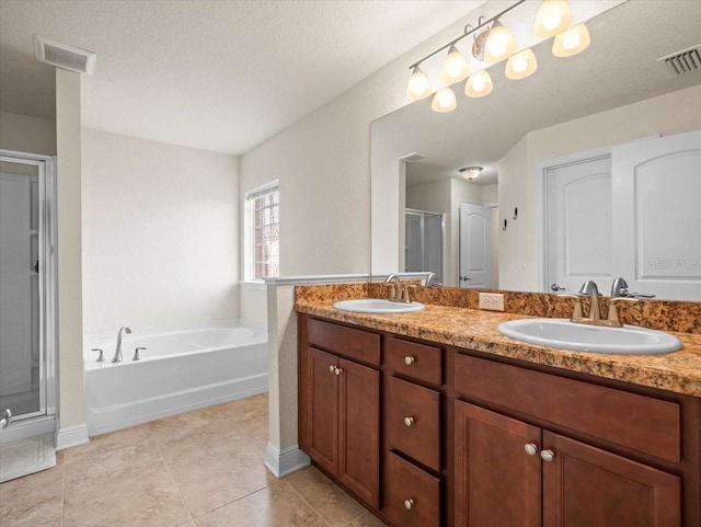 full bath with double vanity, a stall shower, visible vents, and a sink