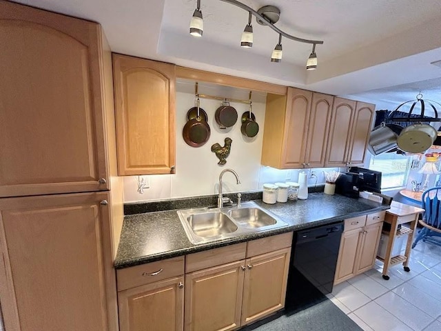 kitchen featuring dark countertops, black dishwasher, a raised ceiling, and a sink