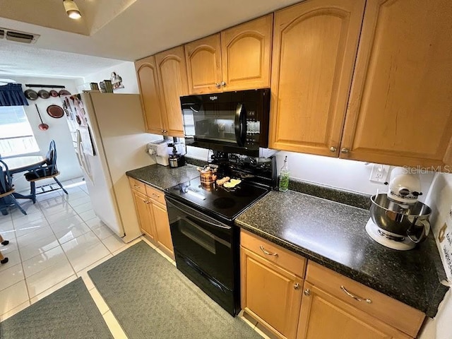 kitchen featuring black appliances, light tile patterned floors, and visible vents