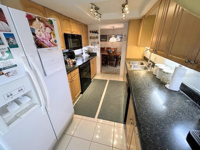 kitchen with a tray ceiling, dark countertops, light tile patterned flooring, a sink, and black appliances