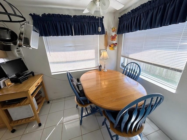 dining room with a ceiling fan and light tile patterned floors