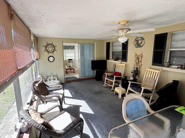 sunroom / solarium featuring a ceiling fan