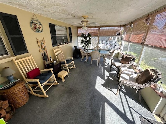 sunroom featuring ceiling fan