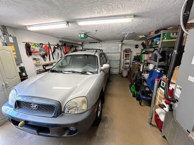 garage featuring electric panel and a garage door opener