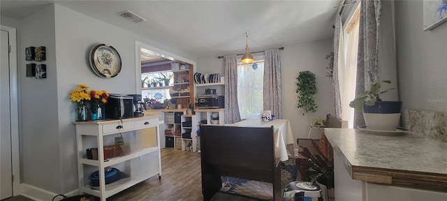 dining area with visible vents and wood finished floors