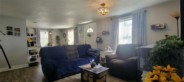 living area with a healthy amount of sunlight, baseboards, and wood finished floors