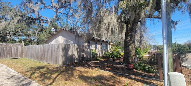 view of side of home featuring fence