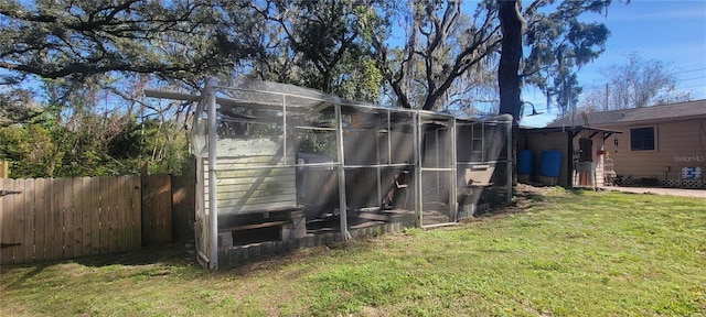 view of outbuilding with fence and an outdoor structure