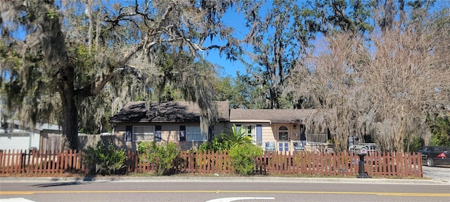 ranch-style house with a fenced front yard