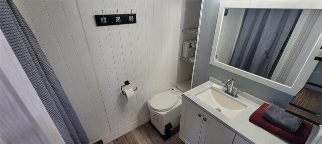 6825 Main St, New Port Richey, FL 34653 - bathroom with vanity, wood walls, and wood finished floors