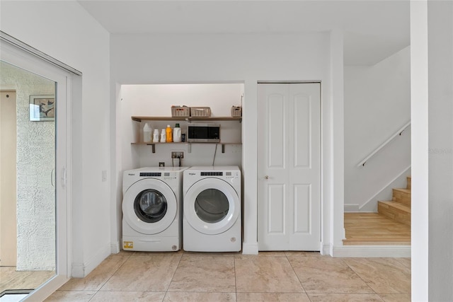 6027 Bayside Key Dr, Tampa, FL 33615 - washroom with laundry area, independent washer and dryer, baseboards, and light tile patterned floors