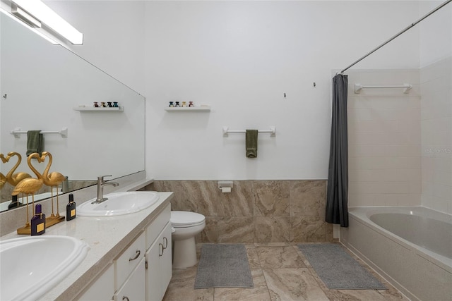6027 Bayside Key Dr, Tampa, FL 33615 - bathroom featuring wainscoting, a sink, tile walls, and toilet