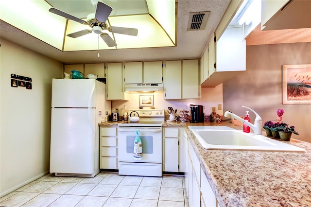 kitchen featuring white appliances, visible vents, light countertops, under cabinet range hood, and a sink