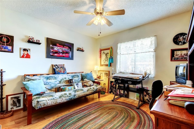 office area with ceiling fan, a textured ceiling, and wood finished floors