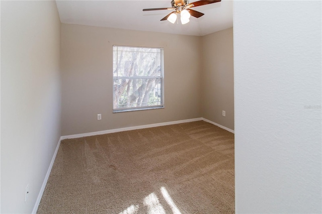 empty room featuring ceiling fan, carpet, and baseboards