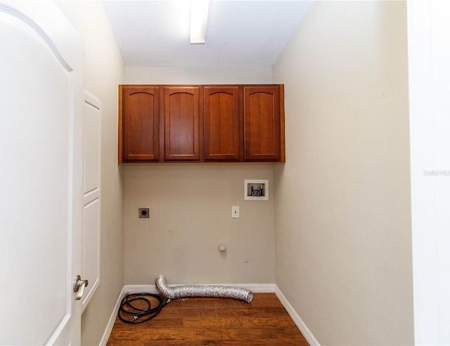 laundry area featuring hookup for a washing machine, hookup for a gas dryer, dark wood-type flooring, cabinet space, and electric dryer hookup