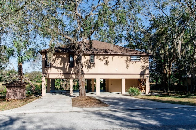 view of front facade with stairway and concrete driveway