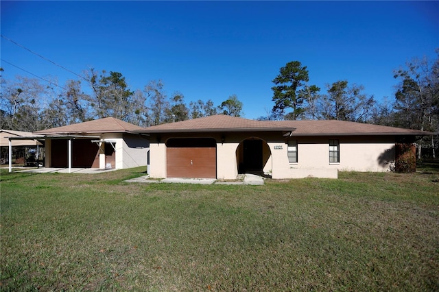 back of property featuring a lawn and stucco siding