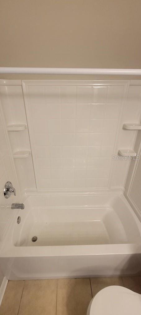 full bathroom with toilet, tub / shower combination, and tile patterned floors