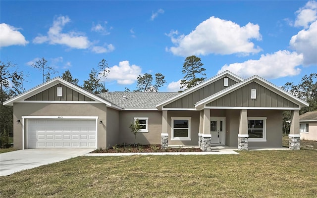 craftsman house featuring a garage, driveway, roof with shingles, board and batten siding, and a front yard