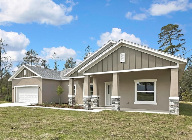 craftsman-style house with board and batten siding, a garage, stone siding, and a front lawn