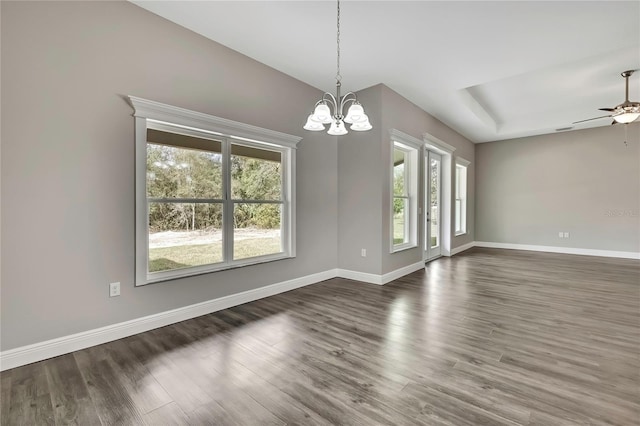 spare room featuring baseboards, wood finished floors, and ceiling fan with notable chandelier