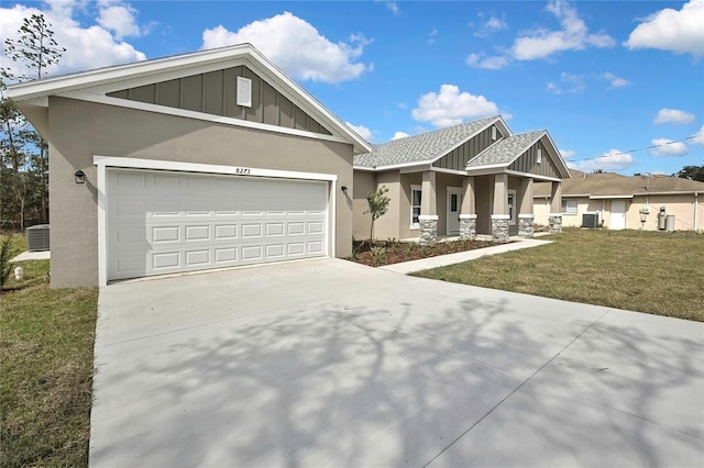 craftsman inspired home with an attached garage, driveway, stucco siding, a front lawn, and board and batten siding