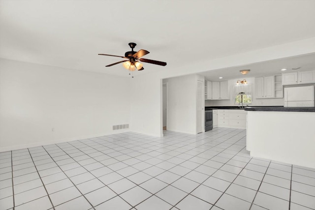 unfurnished living room with recessed lighting, visible vents, light tile patterned flooring, ceiling fan, and baseboards