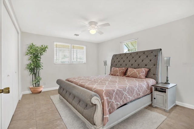 bedroom featuring visible vents, multiple windows, and baseboards