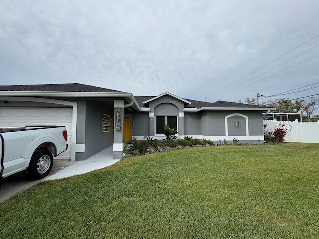 view of front of home featuring stucco siding, a garage, a front yard, and fence