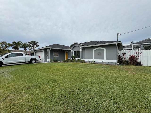 view of front of property featuring a front yard, an attached garage, fence, and stucco siding